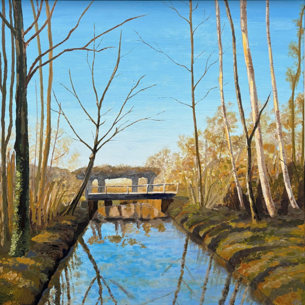 Contemporary figurative acrylic painting with impressionist touches, depicting a peaceful winter landscape with a bridge, bare trees, and blue sky. Cacao Awaits (60x60 cm) by Liane Kusters.
Modern figuratief schilderij met impressionistische stijl van een rustig winterlandschap met een brug, kale bomen en helder blauw water. Cacao Awaits (60x60 cm, acryl op doek) door Liane Kusters.