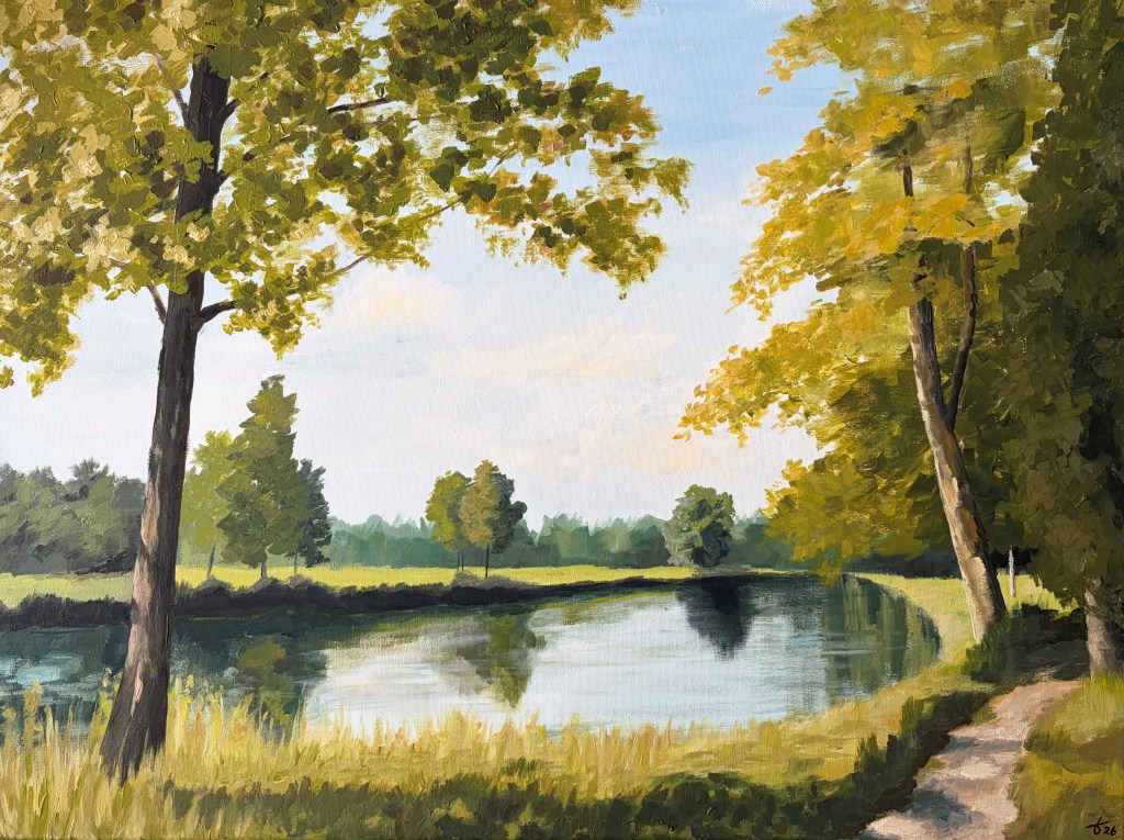 Landscape painting showing a footpath beside calm water, framed by sunlit trees with green foliage. Reflections shimmer on the water beneath a pale blue sky, creating a peaceful late-summer atmosphere.
