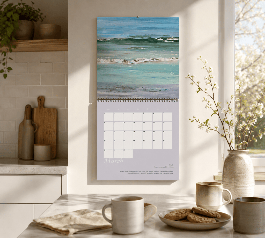Calendar 2027 by Liane Kusters hanging open in a bright modern kitchen, displaying the March artwork and calendar page.